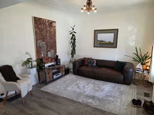 Living area with wood finished floors and hanging lights