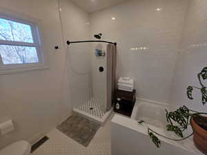Ensuite bathroom with a garden tub, tiled shower, and recessed lighting