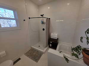 Ensuite bathroom with tiled shower, a garden tub, and recessed lighting