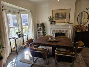 Dining room featuring a fireplace and dark wood finished floors