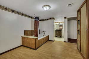 Bathroom with light wood-style floors and a bath