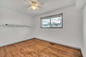 Spare room featuring wood finished floors and ceiling fan