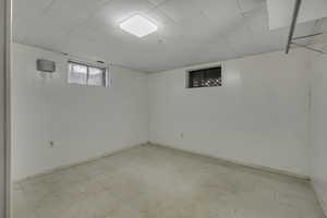 Basement with light flooring and baseboards