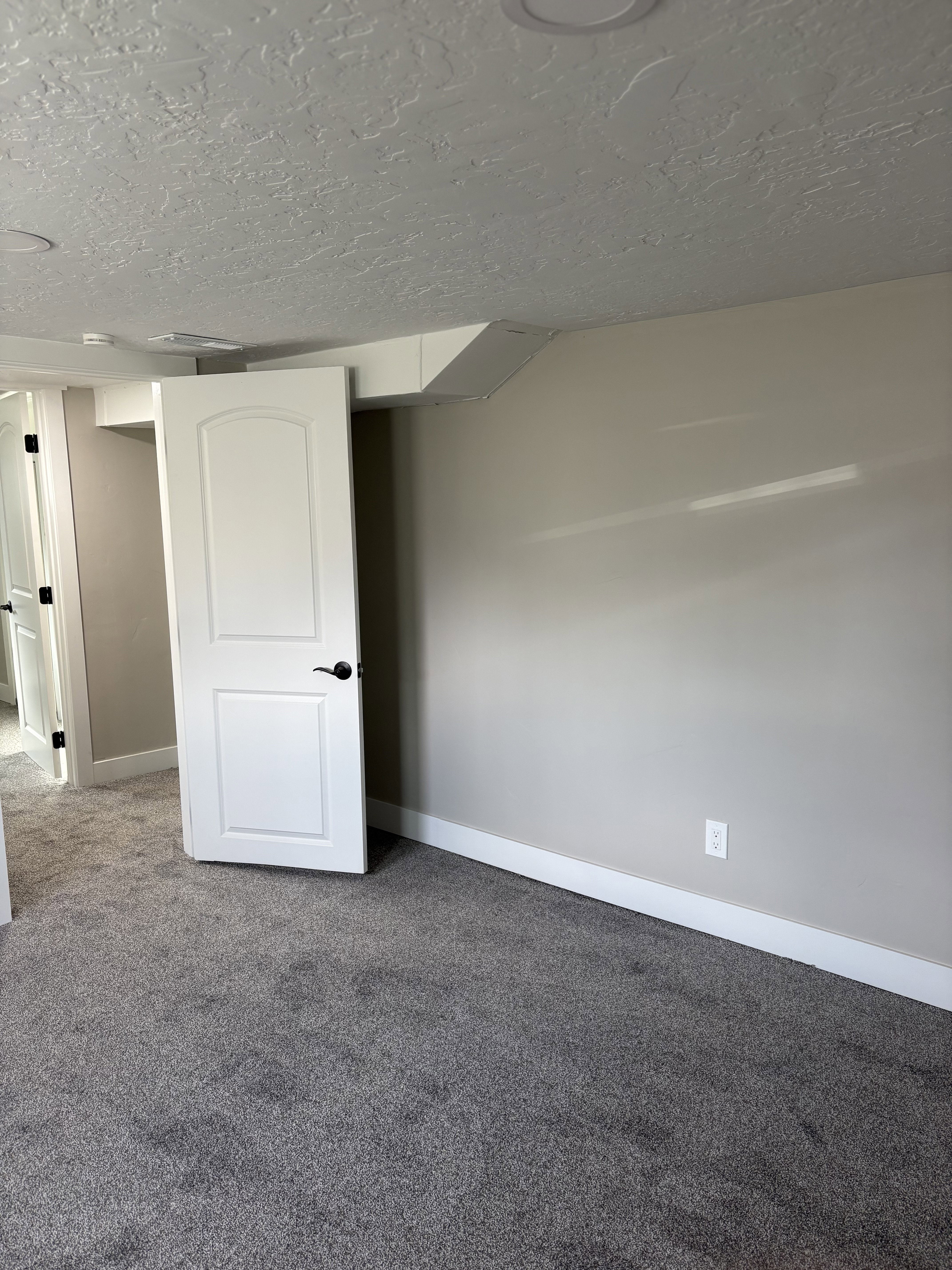 Bedroom 3 light grey carpet floors and a textured ceiling