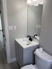 Bathroom with vanity and light laminate flooring