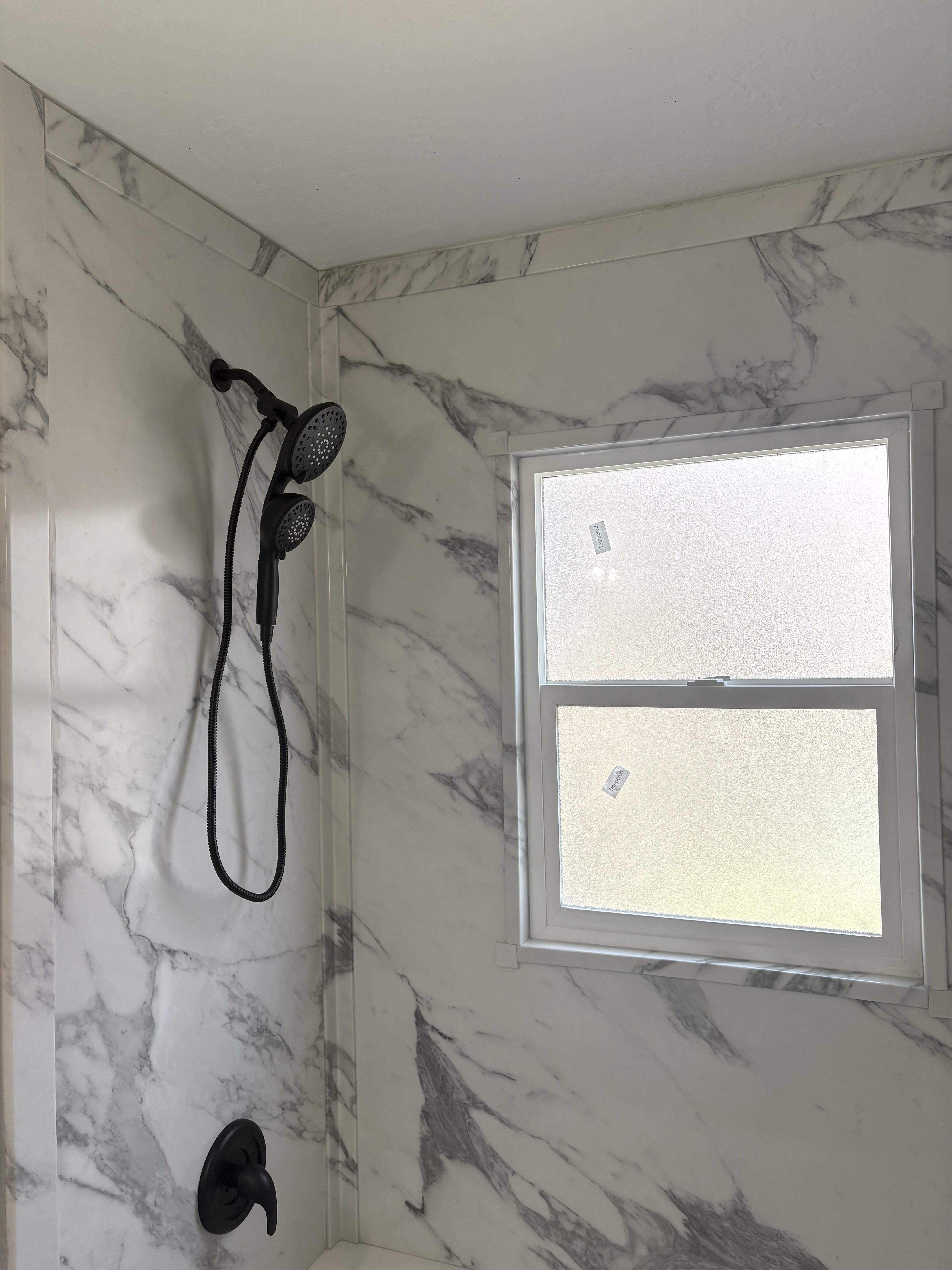 Bathroom with vanity and a combined shower bathtub marble look
