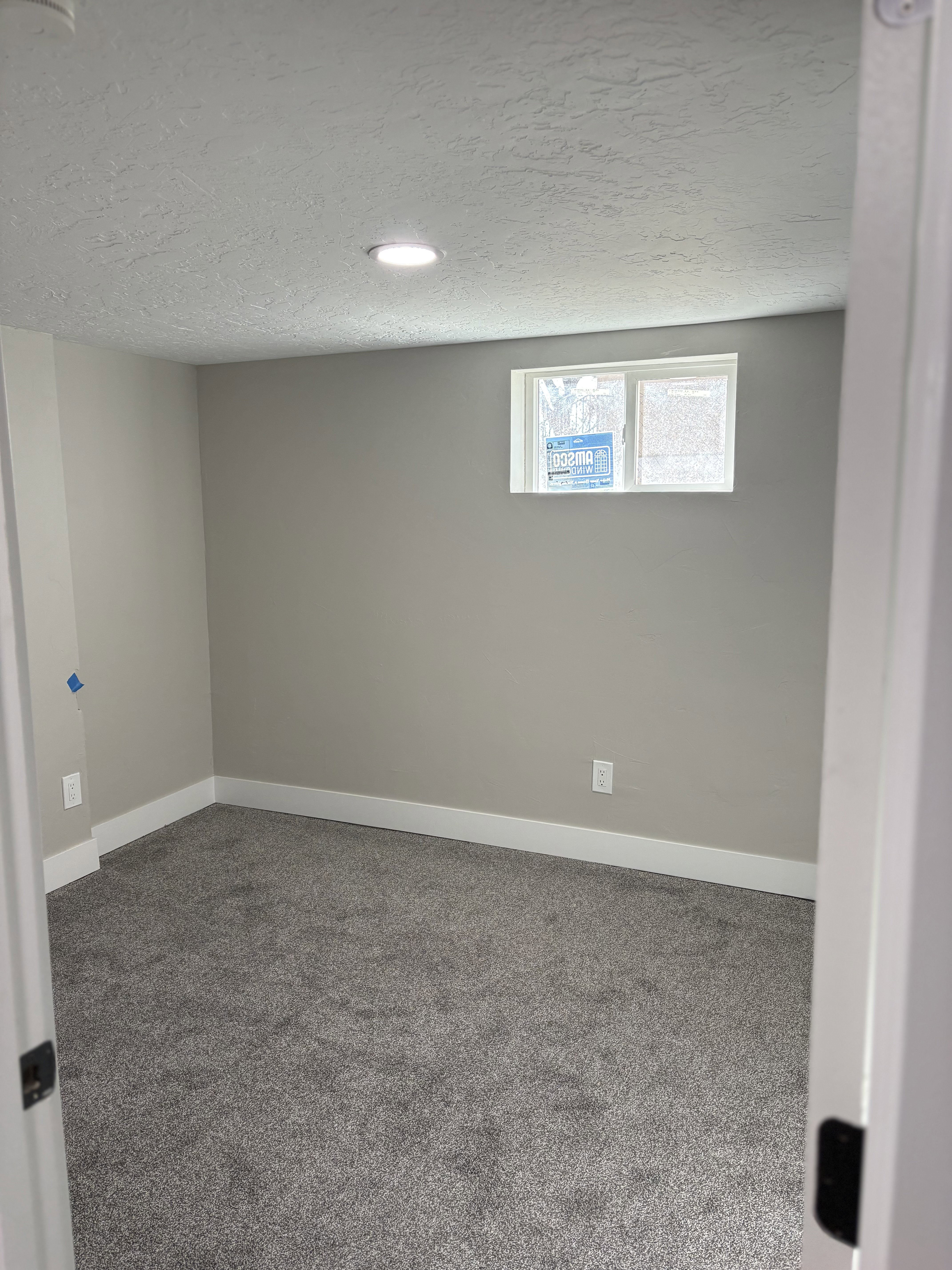 Bedroom 4 light grey carpet floors and a textured ceiling