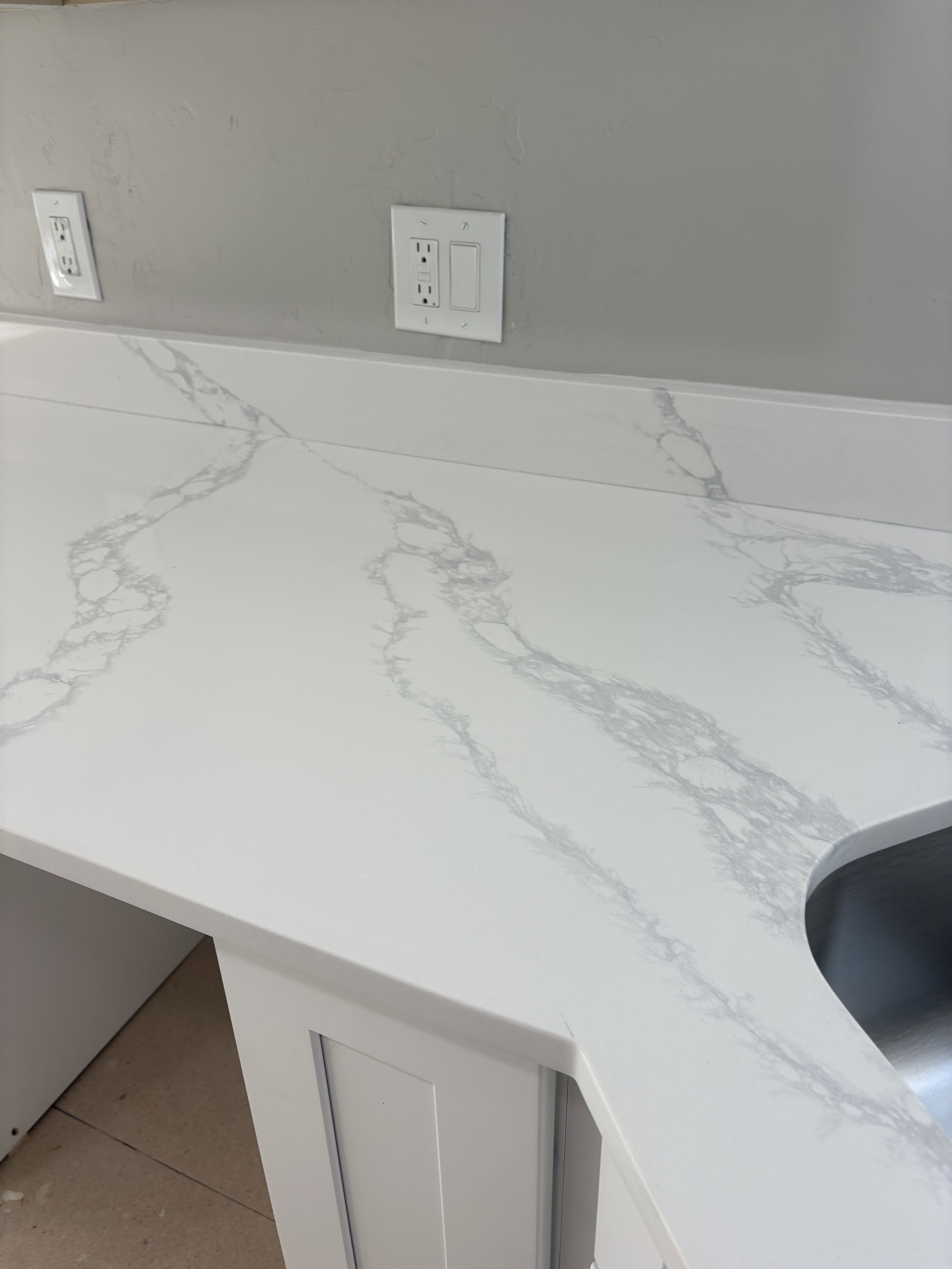 Kitchen view of light stone counters