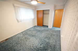Unfurnished bedroom with carpet flooring, a ceiling fan, and a closet