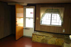 Entryway featuring wooden walls