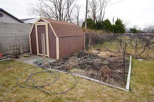 View of shed with a fenced backyard