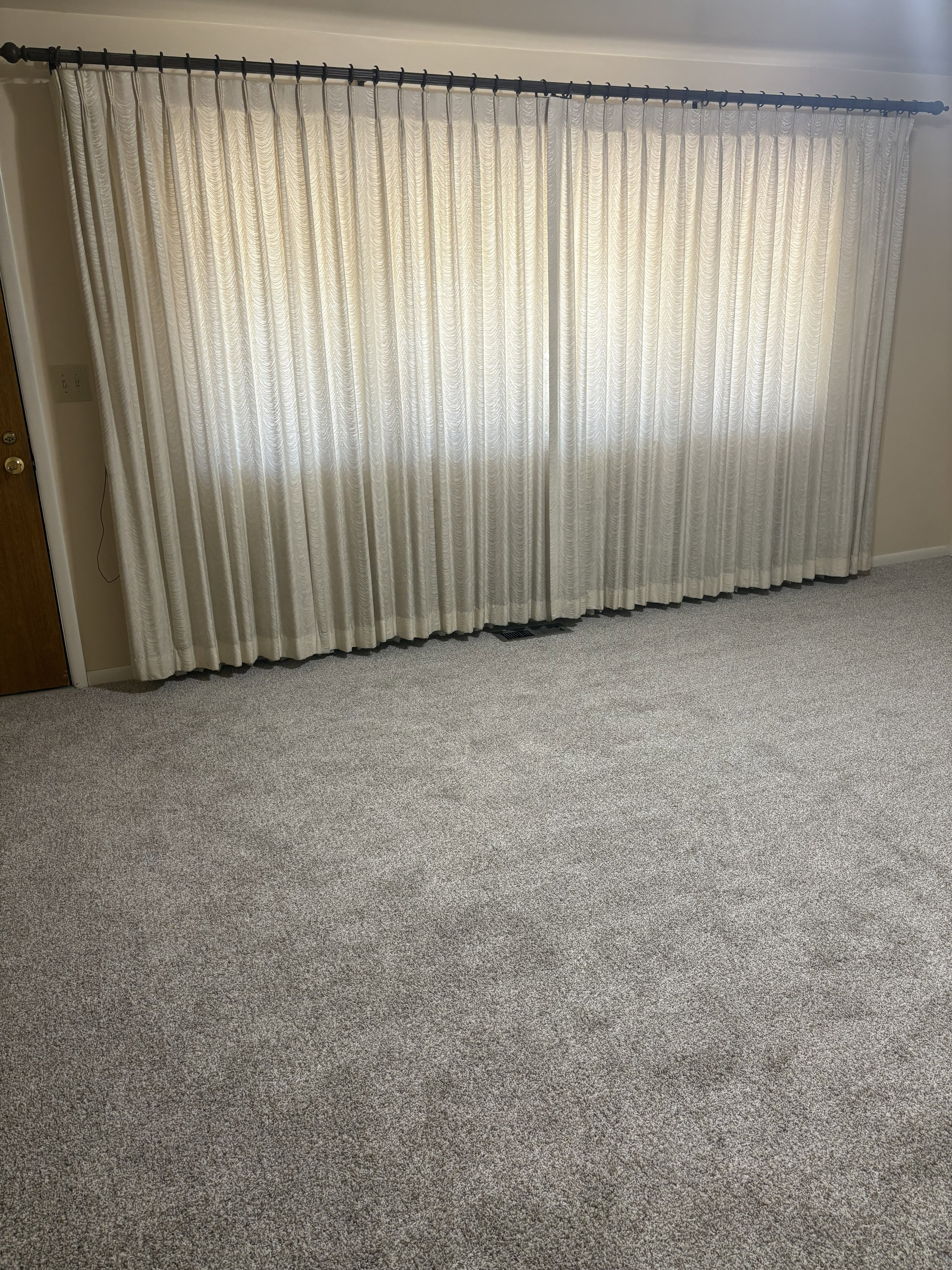 Expansive wall-to-wall carpeting in a neutral gray tone