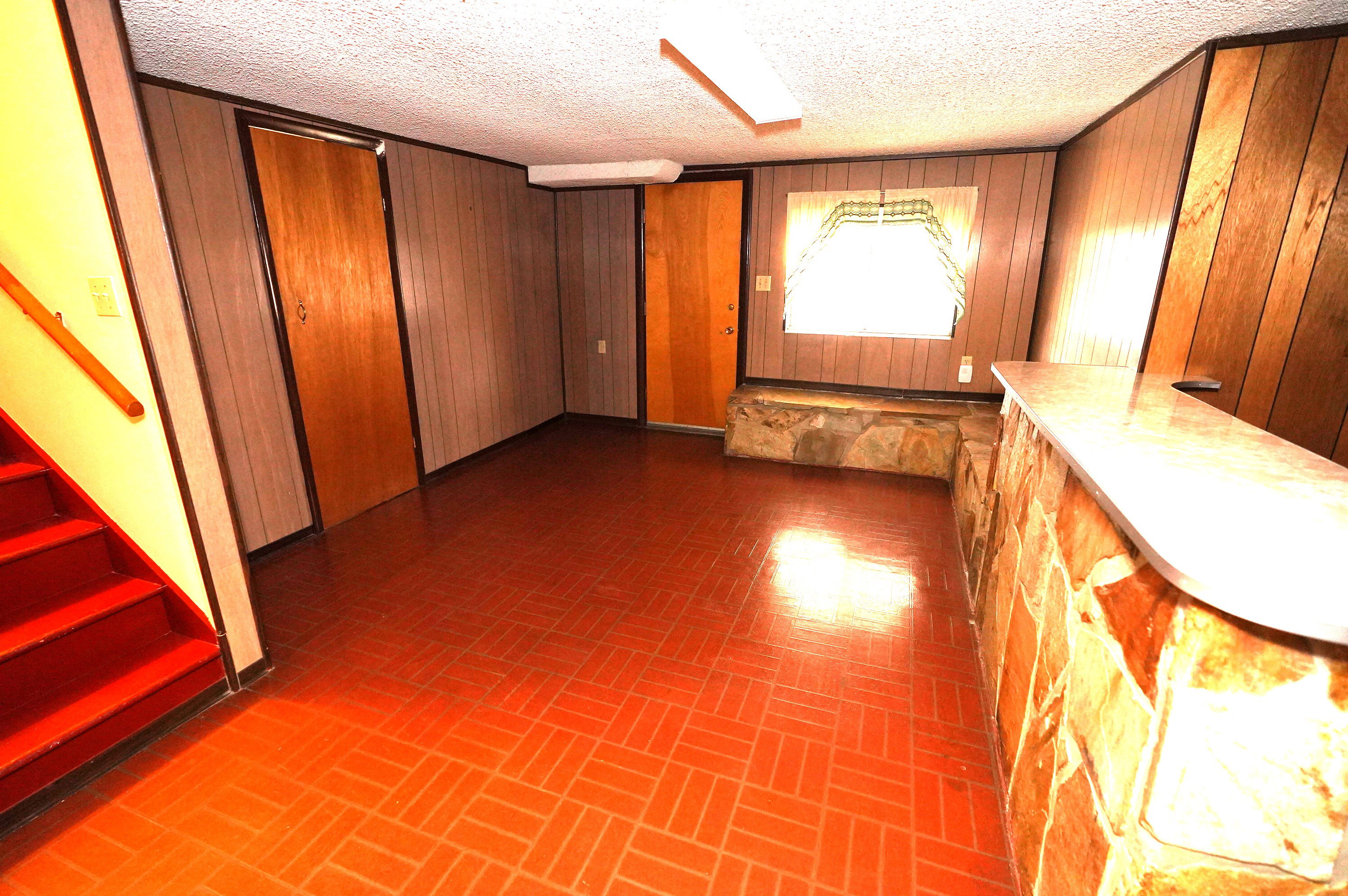 Interior space with wood walls and brick patterned floors