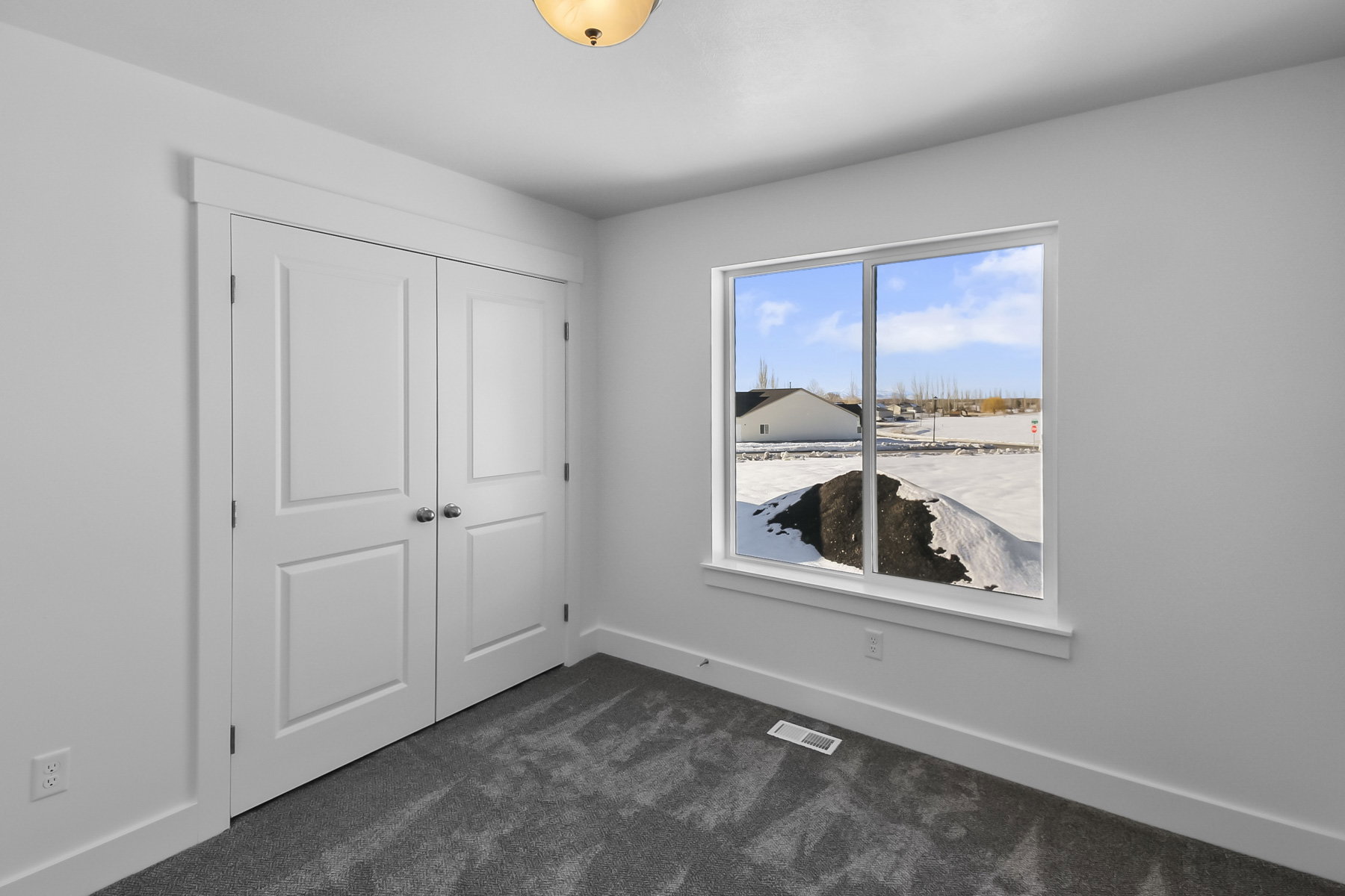 Unfurnished bedroom featuring dark carpet and a closet