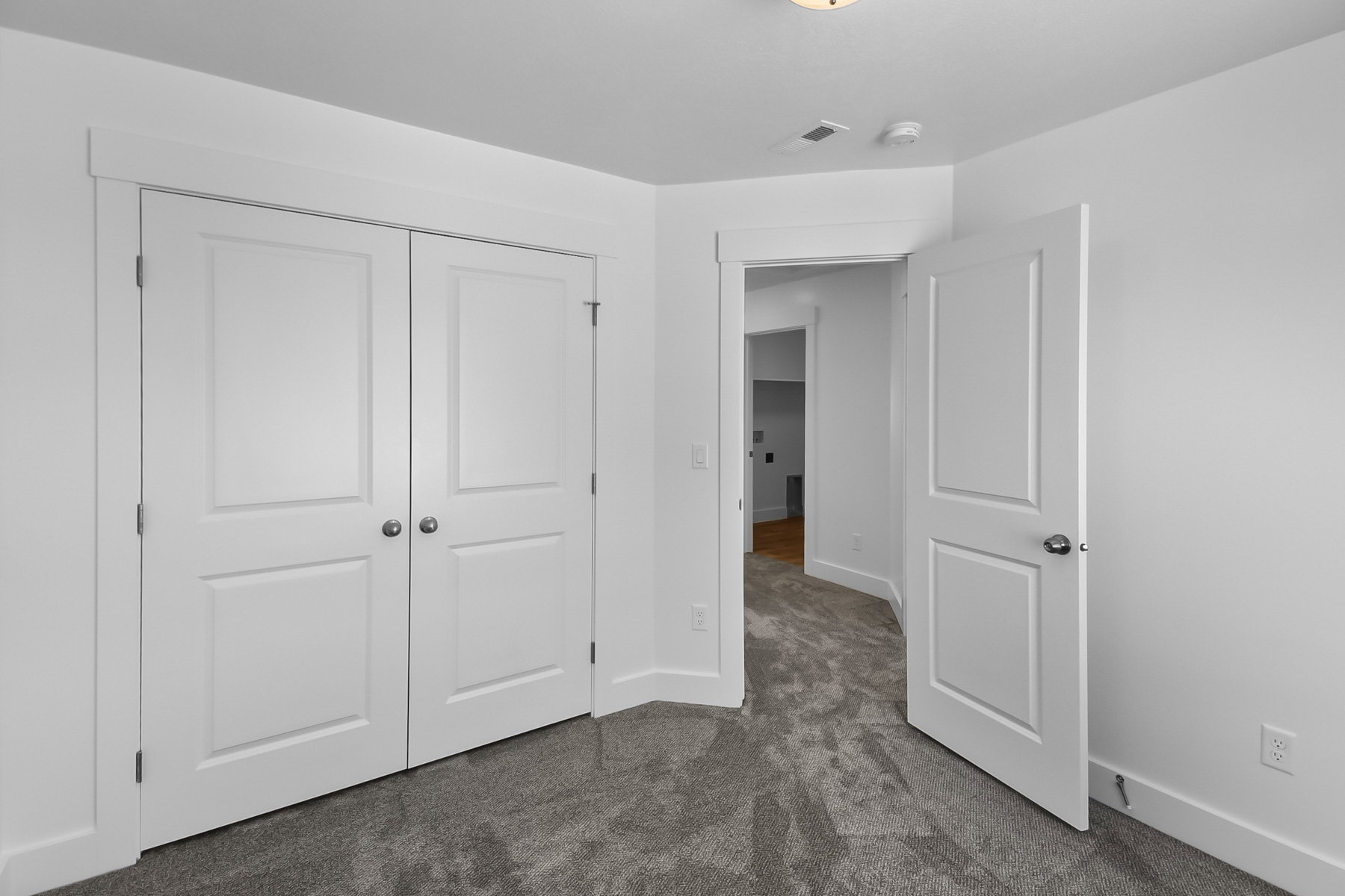 Unfurnished bedroom with dark carpet and a closet