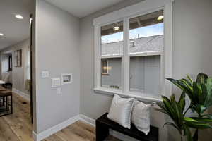 Sitting room with light wood-style flooring and recessed lighting