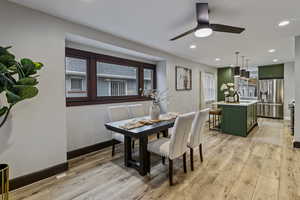 Dining area with light wood-style flooring, recessed lighting, and a ceiling fan
