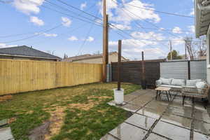 Fenced backyard featuring a patio and outdoor lounge area