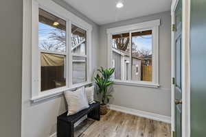 Living area featuring baseboards and light wood-type flooring