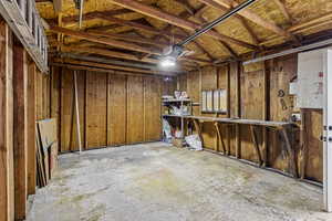 Below grade area featuring a garage and wooden walls