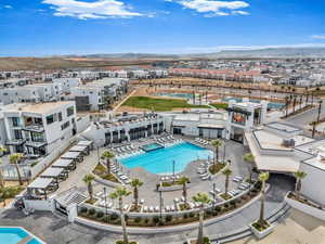 Aerial perspective of suburban area featuring a pool area and mountains