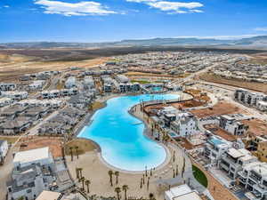 Aerial view of residential area featuring a pool and a mountain backdrop