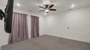 Unfurnished room featuring carpet floors, ceiling fan, and recessed lighting