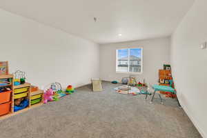 Game room featuring carpet floors and baseboards