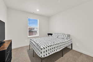 Bedroom featuring light colored carpet and recessed lighting