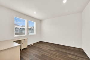 Unfurnished office featuring dark wood-style flooring and recessed lighting
