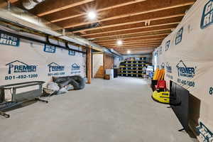 Unfinished below grade area featuring stairway