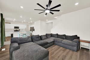 Living area with wood finished floors, recessed lighting, and a ceiling fan