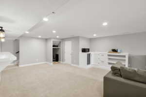 Living area featuring light carpet and recessed lighting