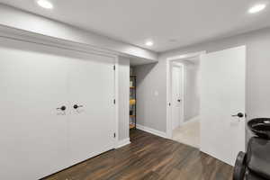 Interior space featuring dark wood-style flooring and recessed lighting