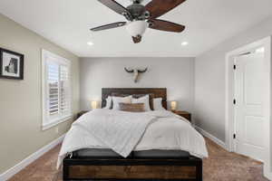 Carpeted bedroom featuring a ceiling fan and recessed lighting