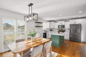 Dining area featuring dark wood-style floors and recessed lighting