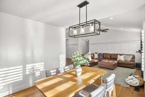 Dining space featuring hardwood / wood-style floors, recessed lighting, a ceiling fan, a decorative wall, and a wainscoted wall