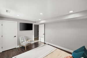 Bedroom featuring recessed lighting, dark wood-type flooring, and a textured ceiling
