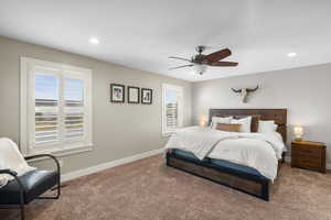Carpeted bedroom with ceiling fan and recessed lighting