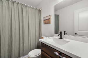 Full bath with vanity and a shower with shower curtain