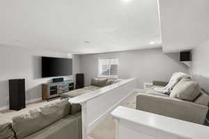 Living room with light colored carpet and recessed lighting