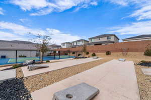 View of yard featuring a tennis court and a residential view