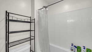 Bathroom with toilet and shower / bath combo