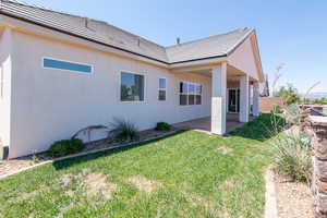 Back of property featuring a patio area, stucco siding, and a tile roof