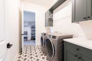 Laundry area featuring cabinet space and washer and dryer