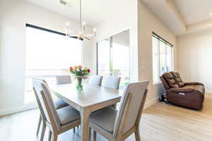 Dining area featuring hanging lights and light wood-style floors