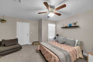 Bedroom featuring carpet flooring, a textured ceiling, and ceiling fan