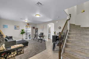Living room featuring arched walkways, wood finish floors, and a textured ceiling