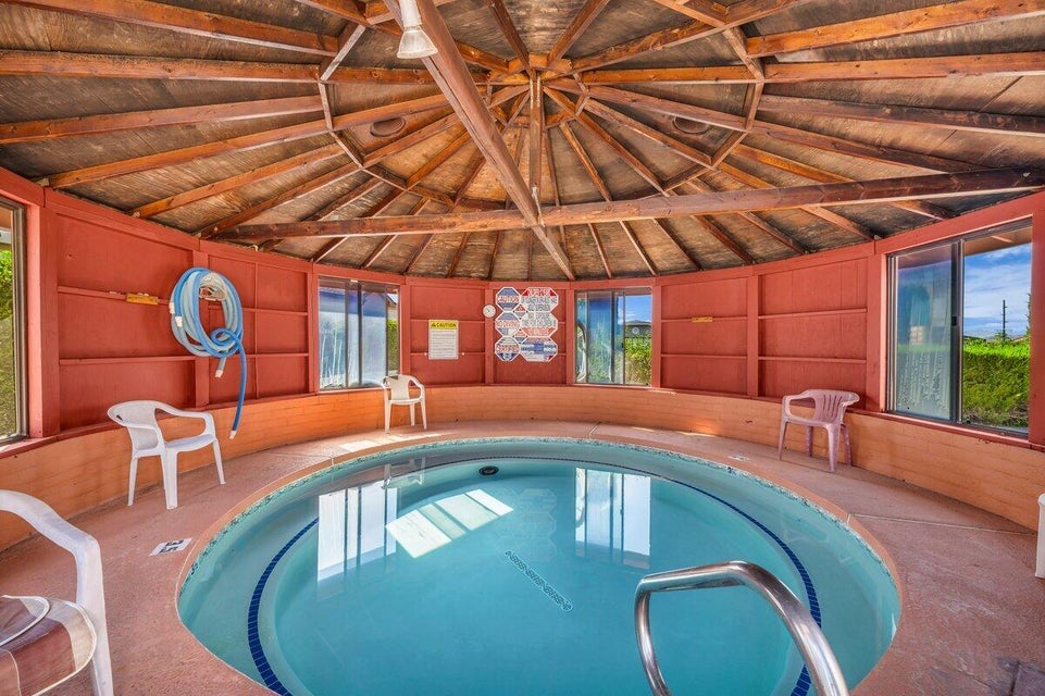 View of pool with an in-ground hot tub and a swimming pool