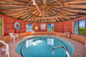 View of pool with an in-ground hot tub and a swimming pool